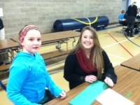 3rd graders make Christmas wreaths with their senior buddies