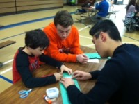 3rd graders make Christmas wreaths with their senior buddies