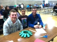 3rd graders make Christmas wreaths with their senior buddies