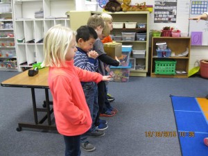 The students praying that the money will be used to bless Komeka.